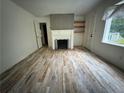 Bright living room features hardwood floors, a fireplace, and large windows at 247 Whitaker Nw Cir, Atlanta, GA 30314
