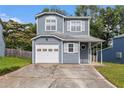 Two-story home featuring an attached garage, inviting curb appeal, and mature trees at 4706 Cedar Park Trl, Stone Mountain, GA 30083
