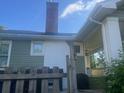 An exterior side angle of a single Gathering home with a red brick chimney and a small covered porch at 3101 E Point St, Atlanta, GA 30344