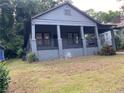 Charming single story home featuring a covered porch and well-manicured front yard at 1053 Metropolitan Sw Pkwy, Atlanta, GA 30310