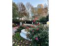 Picturesque landscaping with colorful flowers, manicured hedges, and mature trees creating a serene outdoor environment at 2840 Peachtree Road Nw Nw Rd # 306, Atlanta, GA 30305