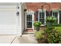 Close-up of the front entrance, showcasing the decorative door and surrounding landscaping at 475 Chippenham Ct, Alpharetta, GA 30005