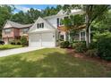 A beautiful two-story home with a well-maintained lawn and an attached two-car garage at 475 Chippenham Ct, Alpharetta, GA 30005