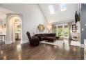 Bright living room with vaulted ceiling, skylights, hardwood floors, and fireplace at 6300 Brookside Pl, Roswell, GA 30076