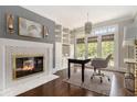 Bright office featuring built-in shelving, fireplace and french doors at 6300 Brookside Pl, Roswell, GA 30076
