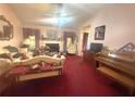 Cozy living room featuring a fireplace, comfortable seating, and a vintage piano at 7133 Babbling Brook Dr, Jonesboro, GA 30236