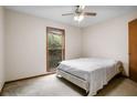 This bedroom features natural light, a ceiling fan, and a bed frame, but is in need of repairs and renovations at 1587 Cronic Town Rd, Auburn, GA 30011