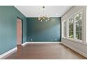 Elegant dining room with hardwood floors, a modern light fixture, and large windows at 1954 Summit Trace Circle Northwest, Atlanta, GA 30318