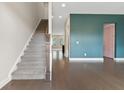 Inviting entryway featuring hardwood floors, a staircase, and stylish wall color accents at 1954 Summit Trace Circle Northwest, Atlanta, GA 30318