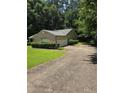 A driveway leads to a one-story home with an attached garage and well-maintained landscaping at 101 Royal Way, Mcdonough, GA 30252