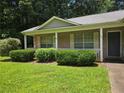 Charming one-story brick home with a covered porch and manicured landscaping at 101 Royal Way, Mcdonough, GA 30252