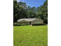 A charming one-story brick home with a manicured lawn and mature trees in the background at 101 Royal Way, Mcdonough, GA 30252