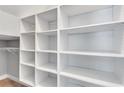 Large walk-in closet with custom built-in shelving, ready for organization at 326 Brownstones Ne Cir, Atlanta, GA 30312