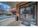 Building entrance featuring brick and concrete with metal doors and a security system at 395 Central Park Ne Pl # 610, Atlanta, GA 30312
