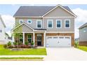 Charming two-story home featuring a brick and siding exterior with a well-manicured front lawn at 13568 Scenic Pkwy, Covington, GA 30014