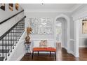 Elegant foyer boasts hardwood floors, stylish mirror, and an staircase with iron railings at 3190 Red Rose Dr, Powder Springs, GA 30127