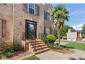 Home exterior with brick facade, landscaped garden, and a welcoming front door with decorative details at 3190 Red Rose Dr, Powder Springs, GA 30127