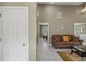 Inviting living room features neutral walls, tiled floor, and an elegant leather sofa at 5900 Union Woods Way, Union City, GA 30291