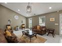 Inviting living room featuring vaulted ceilings, tiled floor, modern lighting, and a stylish layout at 5900 Union Woods Way, Union City, GA 30291