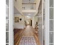 Inviting foyer with hardwood floors, a soaring ceiling, and elegant details at 773 Van Briggle Path, Sugar Hill, GA 30518
