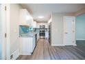 Bright kitchen with stainless steel appliances, granite countertops, a blue backsplash, and modern cabinetry at 10150 Puckett St, Covington, GA 30014