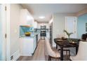 Bright kitchen with stainless steel appliances, granite countertops, a blue backsplash, and modern cabinetry at 10150 Puckett St, Covington, GA 30014