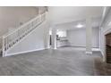 Open-concept living area featuring a staircase, a fireplace, and seamless flow to the modern kitchen at 161 Stoneforest Dr, Woodstock, GA 30189