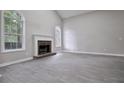 Bright living room features a fireplace and large arched windows, offering a cozy and inviting atmosphere at 161 Stoneforest Dr, Woodstock, GA 30189