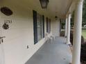 Covered front porch with columns, house number display, seating, and vintage lighting at 1253 Gatewood Drive Dr, Lawrenceville, GA 30043