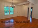 Spacious dining room with hardwood floors, chandelier, and bright natural light at 169 Rachel Blvd, Temple, GA 30179