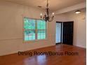 Dining Room featuring hardwood flooring, natural light, with chandelier, and a view of the entry at 169 Rachel Blvd, Temple, GA 30179