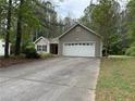 View of single story home with 2 car garage and a driveway with a basketball hoop at 169 Rachel Blvd, Temple, GA 30179