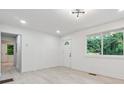 Bright and airy living room featuring new flooring and ample natural light through the window at 4443 Flat Shoals Pkwy, Decatur, GA 30034