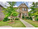 Charming two-story home featuring a well-kept lawn and a welcoming front porch at 4895 Sterling Close, Buford, GA 30518