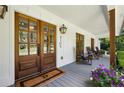 Elegant front entrance with stained wood doors and charming porch decor at 6175 Weatherly Nw Dr, Sandy Springs, GA 30328
