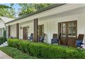 Inviting front porch with wooden chairs and well-maintained landscaping at 6175 Weatherly Nw Dr, Sandy Springs, GA 30328