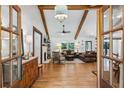 Warm, inviting living room featuring exposed beams, wood floors and lots of natural light at 6175 Weatherly Nw Dr, Sandy Springs, GA 30328