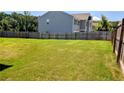 Large, grassy backyard, perfect for outdoor activities and entertaining, surrounded by a wood fence at 15 Regal Ln, Covington, GA 30016