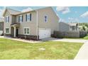 Well-maintained home with an attached garage and a spacious, neatly manicured lawn at 15 Regal Ln, Covington, GA 30016
