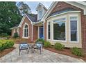 Welcoming front facade with a cozy seating area and blue front door at 215 Settindown Ct, Roswell, GA 30075