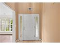 Inviting entryway with a white front door, sidelights, and tile flooring at 504 Bradford Park Ct, Loganville, GA 30052
