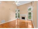 Bright living room with vaulted ceilings, a fireplace, and large windows at 504 Bradford Park Ct, Loganville, GA 30052
