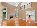 Spacious living room with fireplace, hardwood floors and view of the Kitchen at 504 Bradford Park Ct, Loganville, GA 30052