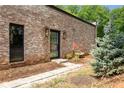 Exterior shot features a black door, brickwork, and manicured landscaping at 538 Main St, Palmetto, GA 30268