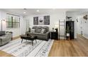 Bright living room with a comfortable sofa, decorative rug, and a view to outside at 107 Barrington Hills Dr, Atlanta, GA 30350