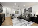 Modern living room boasts a fireplace, comfortable seating, and stylish decor at 107 Barrington Hills Dr, Atlanta, GA 30350