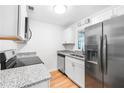 Modern kitchen featuring stainless steel appliances, granite countertops, and ample cabinet space at 191 High Creek Dr, Roswell, GA 30076