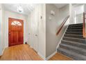 Entryway with hardwood floors, a wooden front door, and carpeted stairs at 2117 Chestnut Hill Circle Cir, Decatur, GA 30032