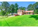 Traditional two-story brick home with a large front lawn and mature trees at 2117 Chestnut Hill Circle Cir, Decatur, GA 30032