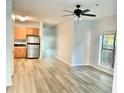 Open concept living area with light wood flooring, ceiling fan, window and stainless steel appliances at 238 Walker Sw St # 22, Atlanta, GA 30313